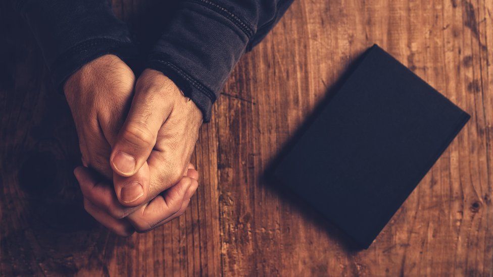 Hands and a bible
