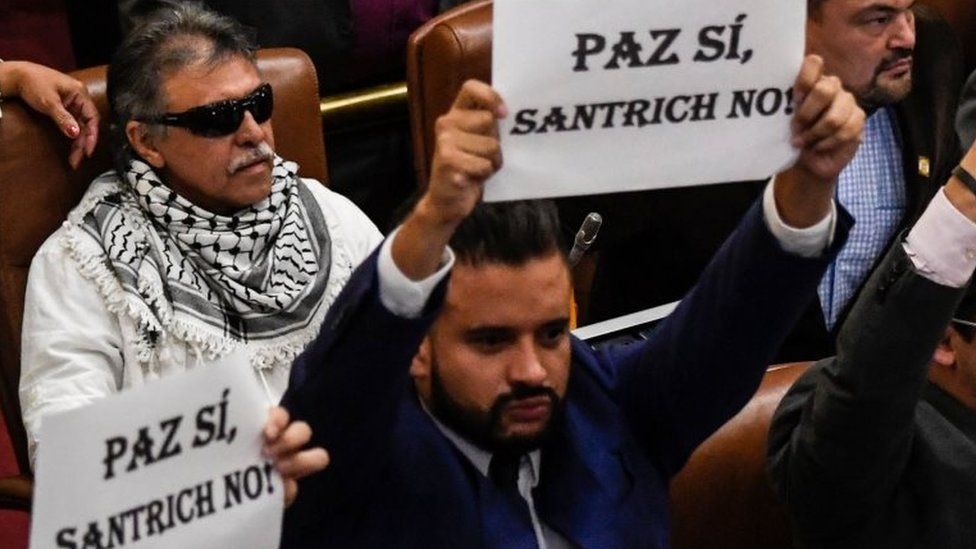 Jesus Santrich occupies his deputy seat at Colombian National Congress next to others deputies demonstrating against his presence at the lower house in Bogota, on June 12, 2019