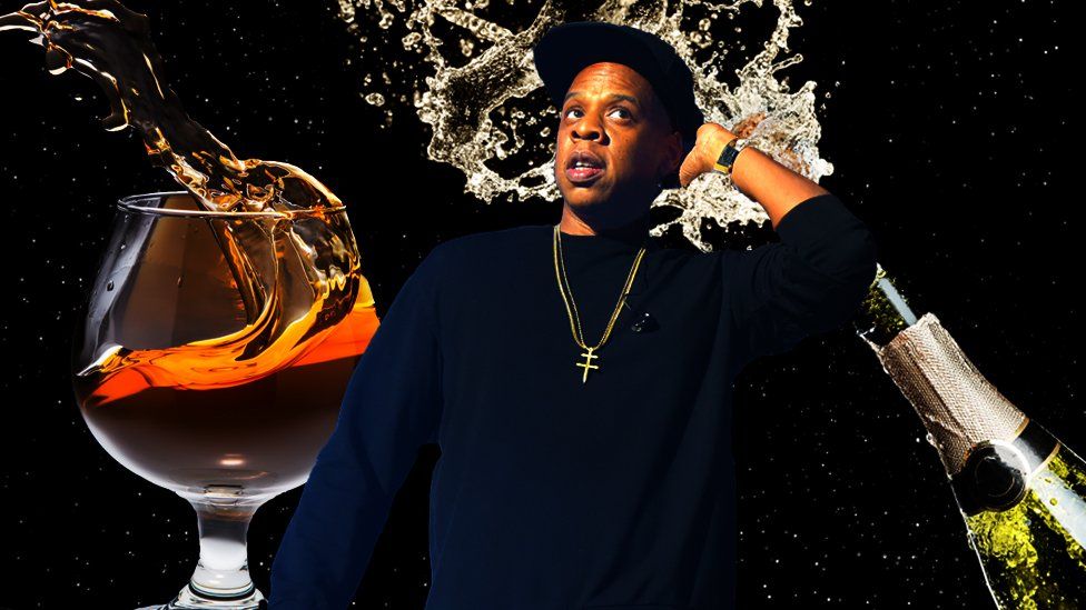 Jay Z with champagne and cognac splashing in the background