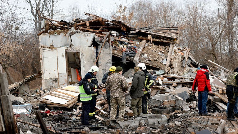 Rescue teams examine a damaged home in the Kyiv region