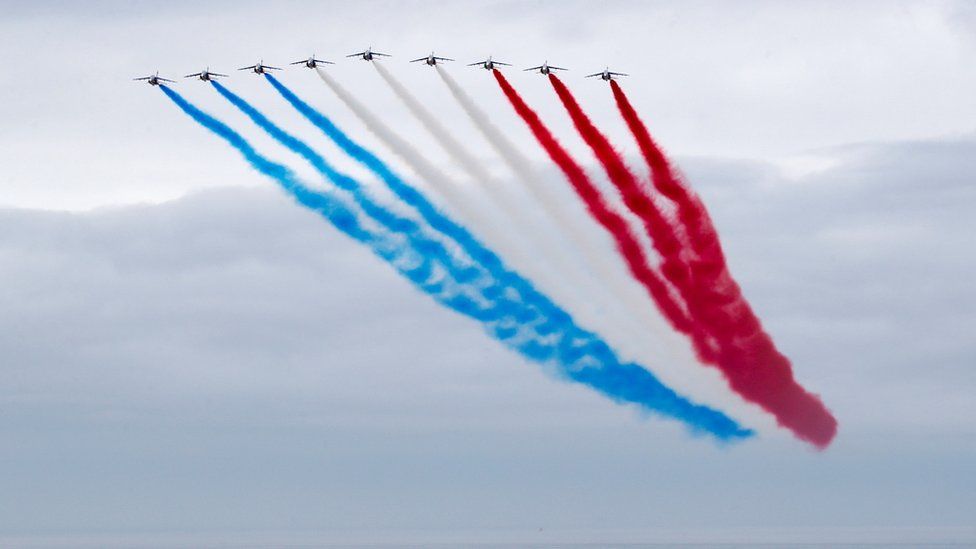 The Red Arrows flying over the Normandy Memorial