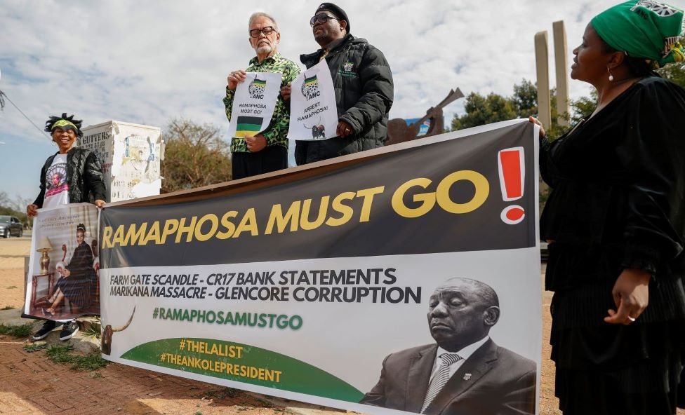 Disgruntled African National Congress (ANC) members demonstrate together with with former ANC spokesman Carl Niehaus (C-L) as they hold posters reading Ramaphosa Must Go outside the National Recreation Center (Nasrec) in Johannesburg on July 31, 2022