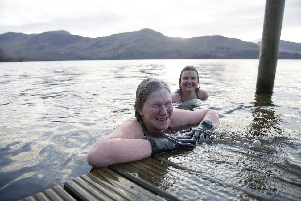 Two women swim in open waters