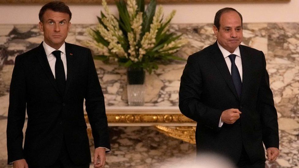 French President Emmanuel Macron (L) and Egyptian President Abdel-Fattah al-Sisi arrive to give a press conference following their talks in Cairo, on October 25, 2023
