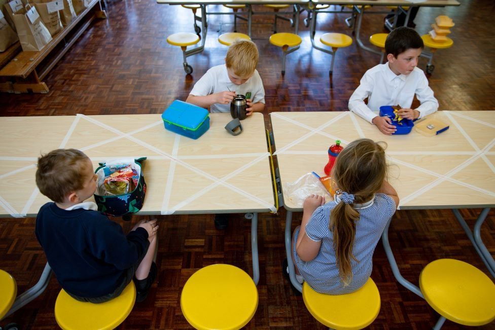 May 18 2020. Children of essential workers eat lunch in segregated positions at Kempsey Primary School in Worcester. Nursery and primary pupils could return to classes from June 1 following the announcement of plans for a phased reopening of schools.