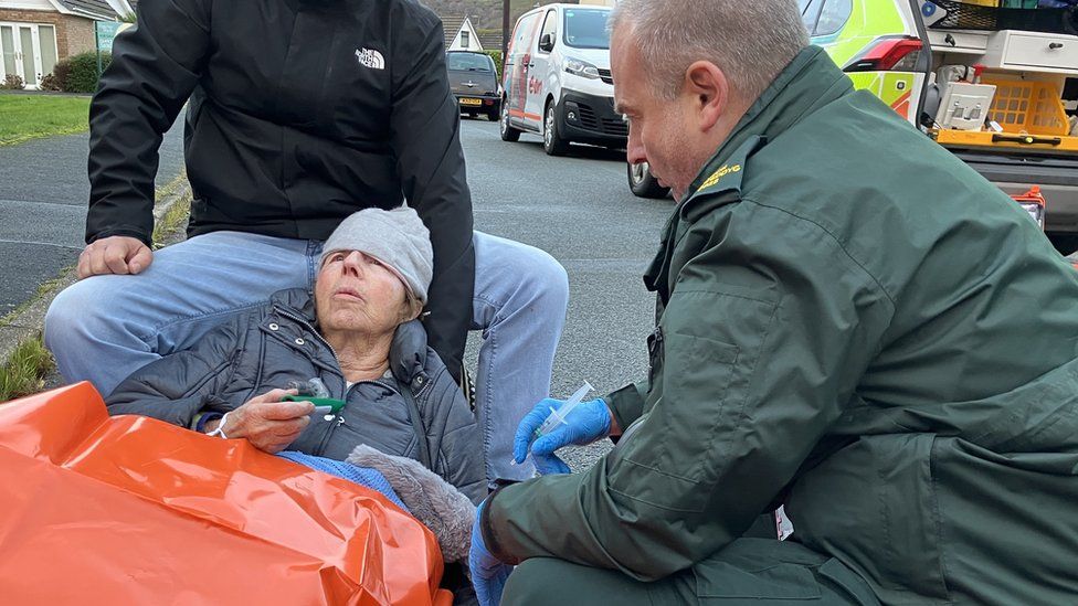 Advance paramedic Aled Williams treats Jenny, who had a fall in the street