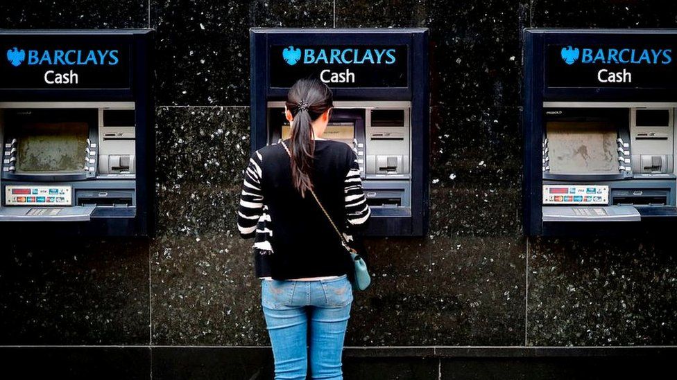 Woman at Barclays cash point