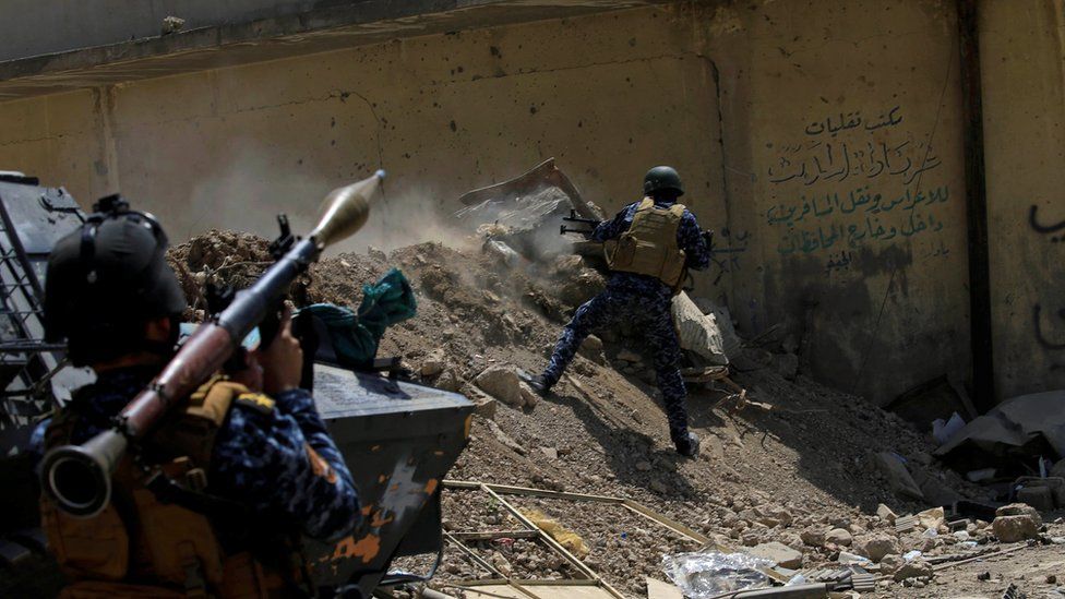 An Iraqi Federal Police member fires towards Islamic State militants during a battle in western Mosul, Iraq, May 28, 2017