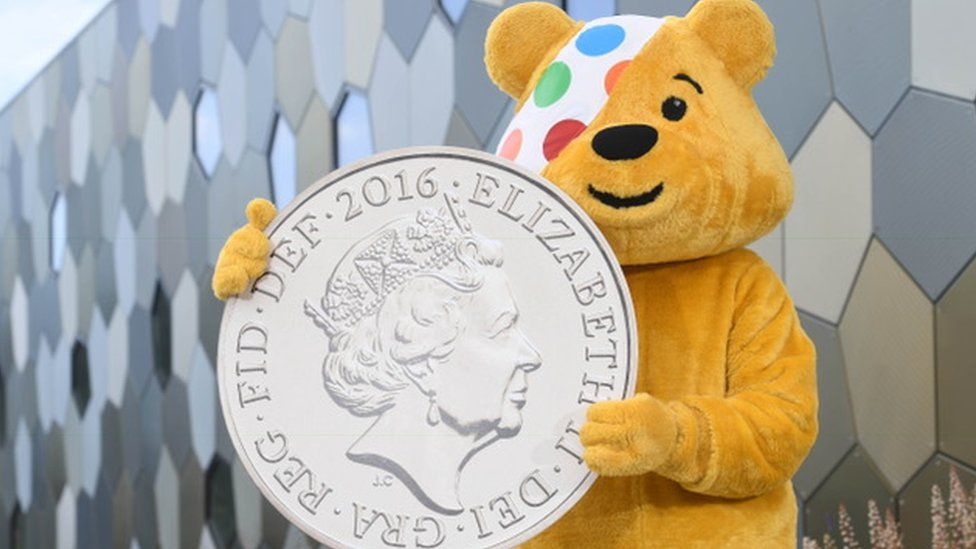 Pudsey Bear with a coin