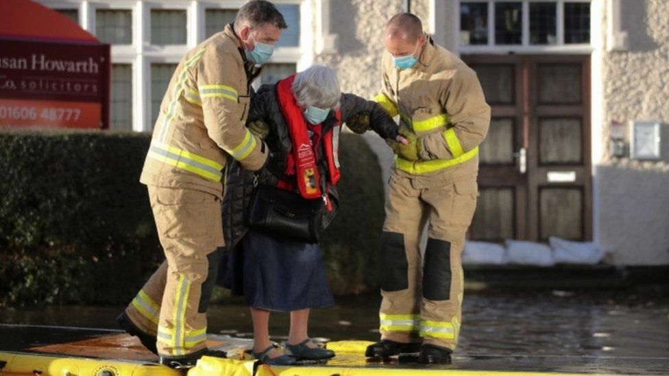 Firefighters helping people to safety