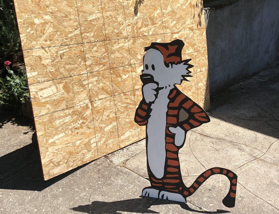 Plywood chunk with a wooden cutout of Hobbes, the sarcastic tiger from Calvin and Hobbes