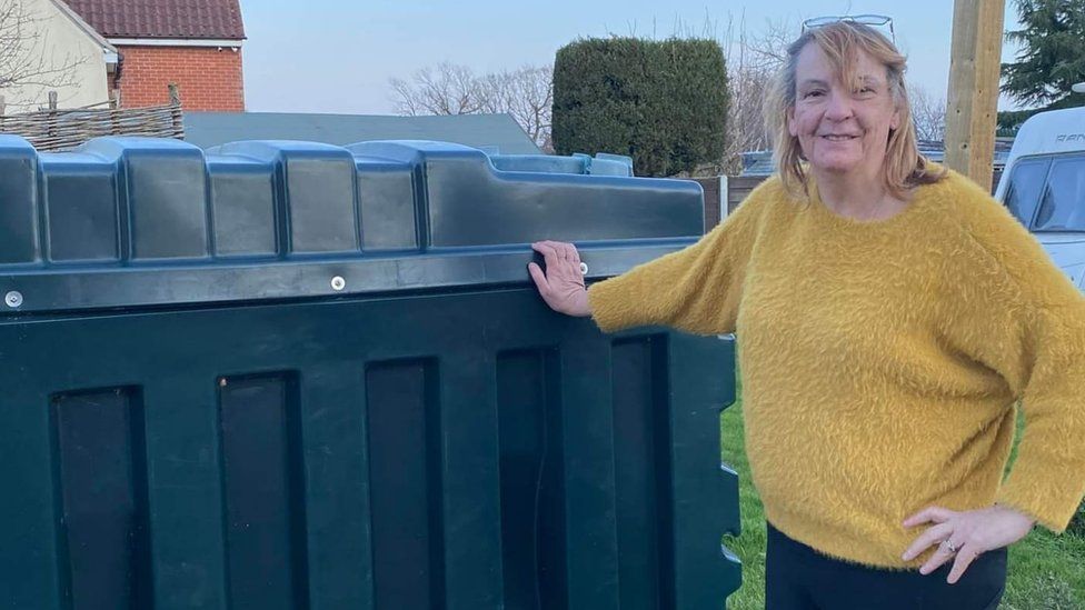 Eira Featley next to her heating oil tank