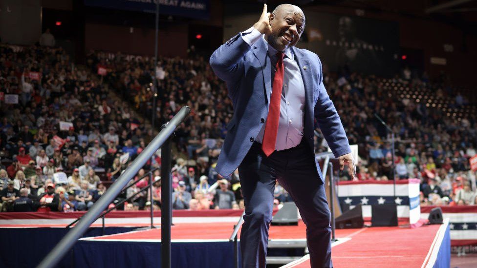 Senator Tim Scott (R-SC) urges supporters to cheer for Republican presidential candidate and former President Donald Trump