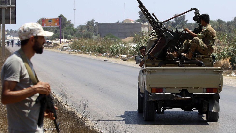 Libyan security forces patrol a checkpoint east of Tripoli, 23 August 2018