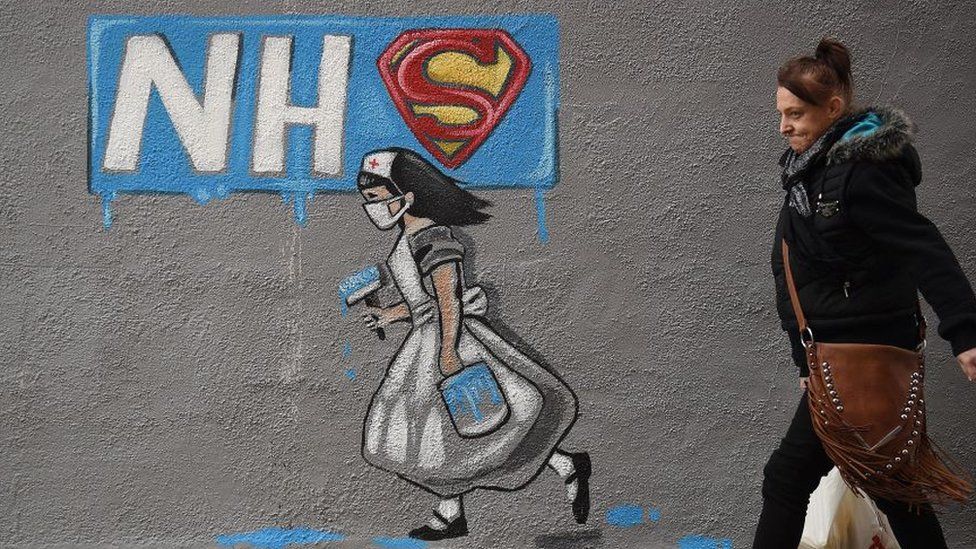woman walking past graffiti