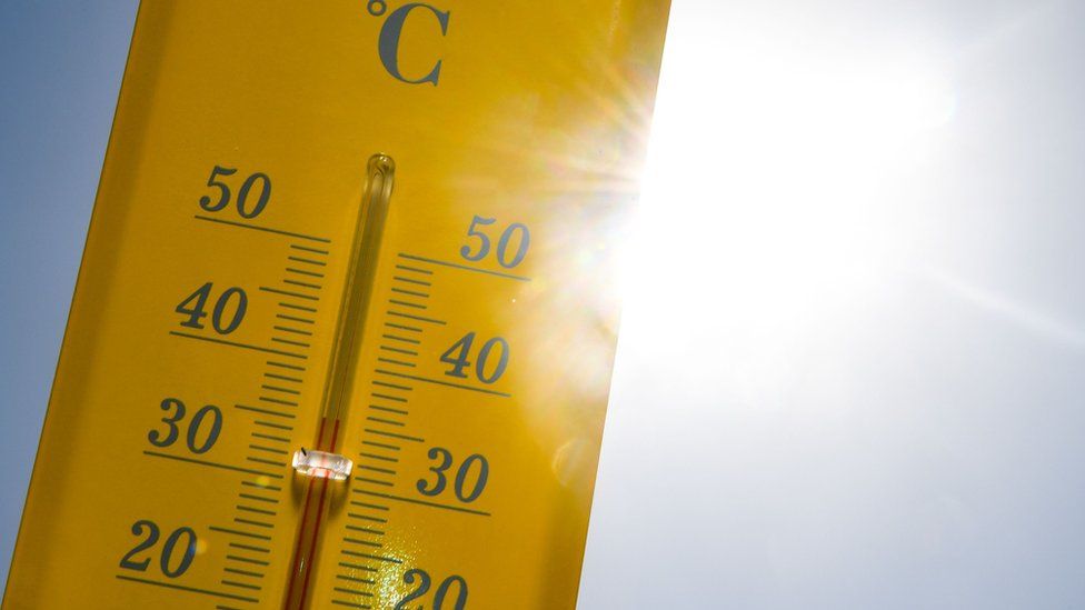 A thermometer is seen in the sun during the heatwave in Rennes, France