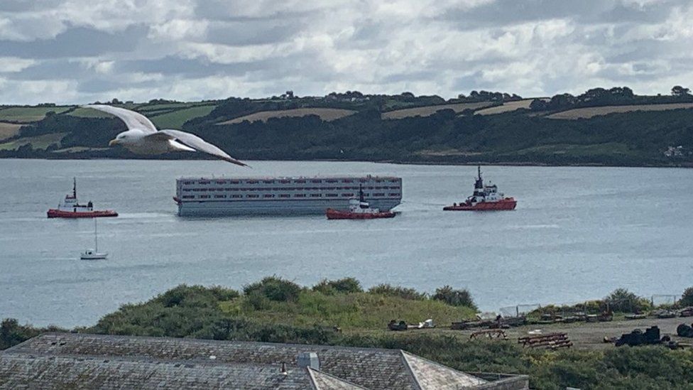 Bibby Stockholm being towed out of Falmouth