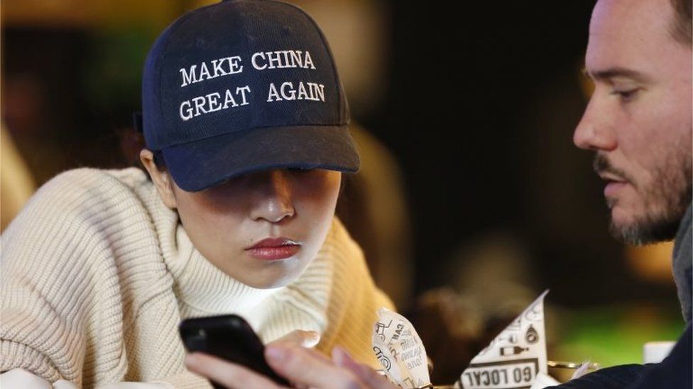 A woman wears a cap with a China message that is reminiscent of the campaign slogan of US President-elect Donald Trump "Make America Great Again," at a bar in Beijing, China, 09 November 2016.