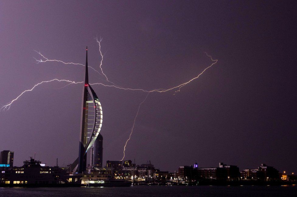 Lightning flashes near the Spinnaker Tower in Portsmouth as overnight thunderstorms swept across Britain