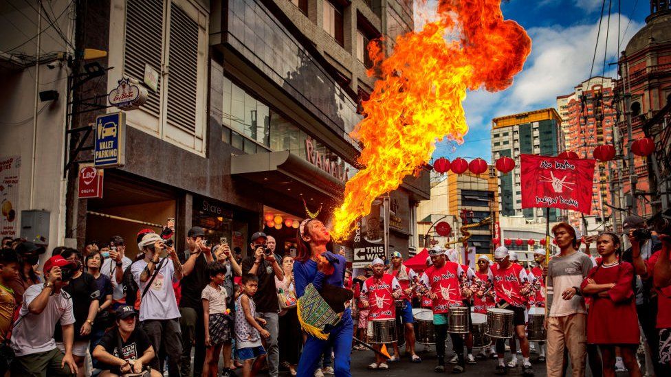A performer breathes fire during Lunar New Year celebrations at Binondo district, considered the world's oldest Chinatown, on February 10, 2024 in Manila, Philippines.
