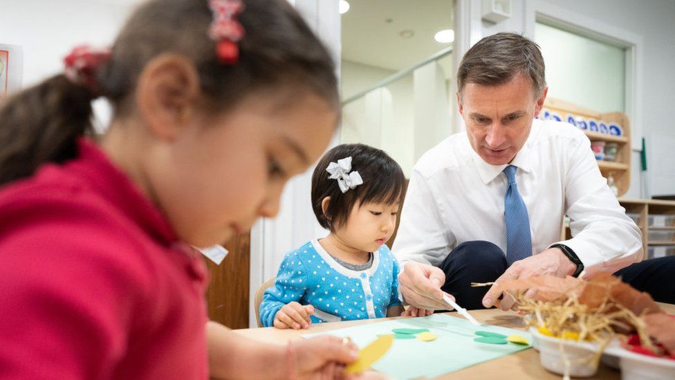 Chancellor Jeremy Hunt helping toddlers with artwork at Busy Bees Battersea Nursery in south London