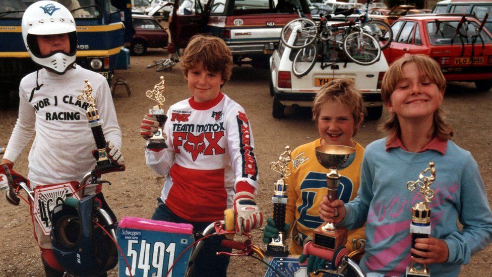 children pose with trophies