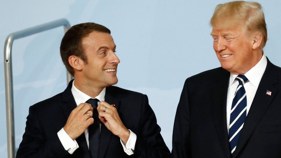 US President Donald Trump (R) and French President Emmanuel Macron talk at the G20 summit in Hamburg on 7 July