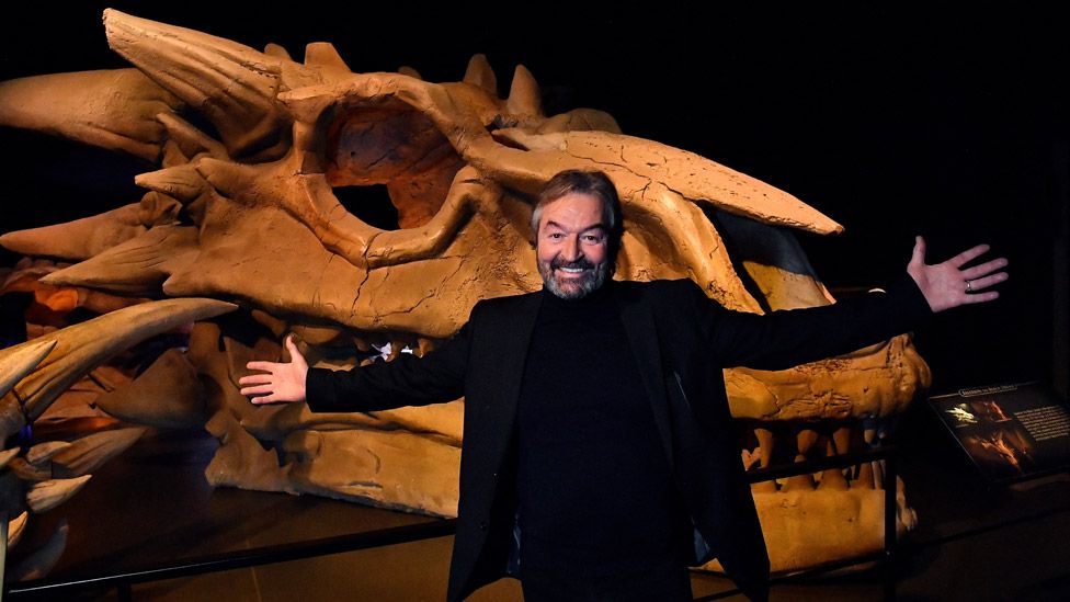 Actor Ian Beattie, who played Meryn Trant, with a dragon skull at the Game of Thrones Studio Tour