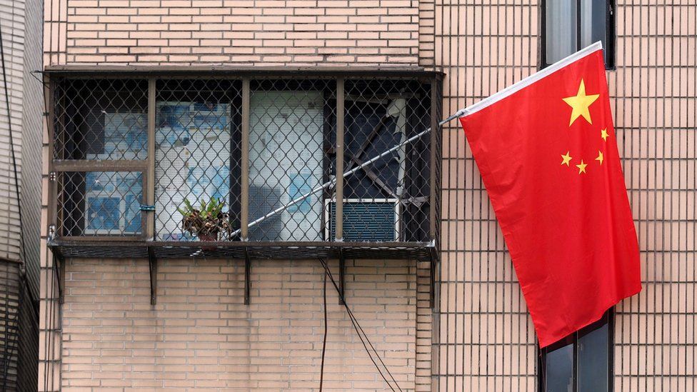 Chinese national flag hanging from a window