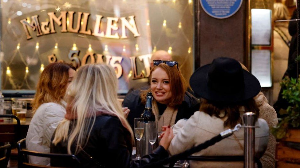 Women drinking outside a pub in Covent Garden, London
