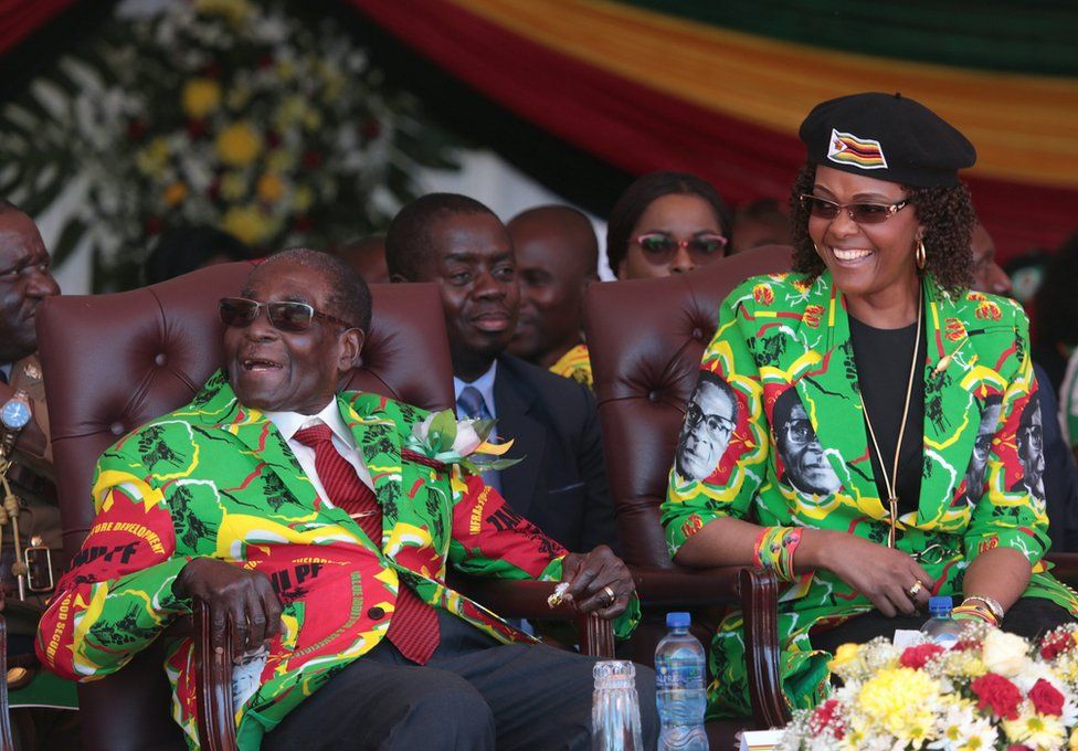 Zimbabwean President Robert Mugabe (L) and his wife Grace (R) smile after arriving at the Rudhaka Stadium in Marondera, about 100 kilometers east of Harare