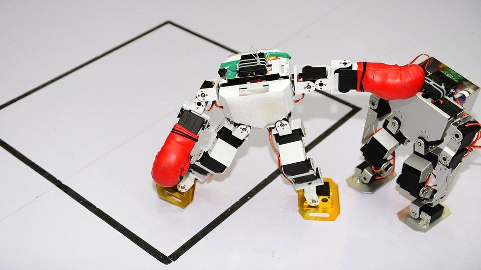 Two robots fight in a humanoid fighting competition during the 2016 China RoboWork Competition International Open at Rizhao Campus of Shandong Sport University on May 28, 2016 in Rizhao, Shandong Province of China.