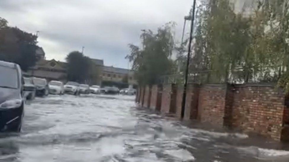 Flooded road with a queue of cars