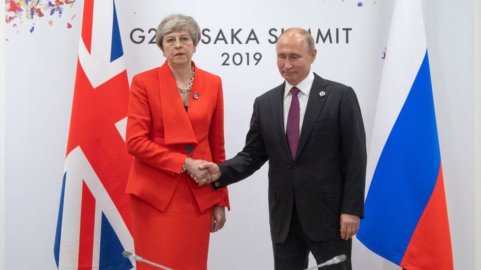 Theresa May shaking hands with Vladimir Putin