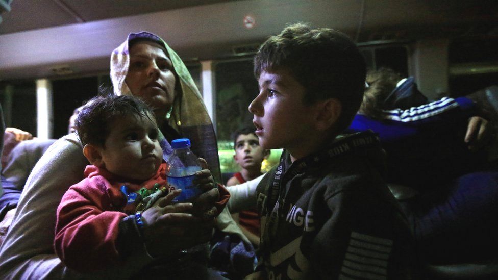Syrian displaced families, who fled violence after the Turkish offensive against Syria, sit in a bus after arrival at a refugee camp in Bardarash on the outskirts of Dohuk, Iraq October 17,
