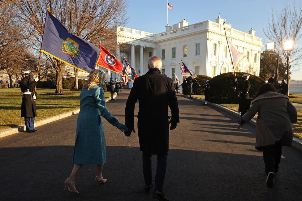 President Joe Biden and First Lady Dr Jill Biden walk up to the White House