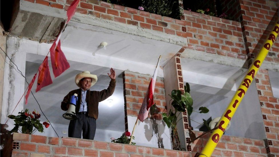 Pedro Castillo waves to supporters in the town of Tacabamba, as he waits for votes to be counted