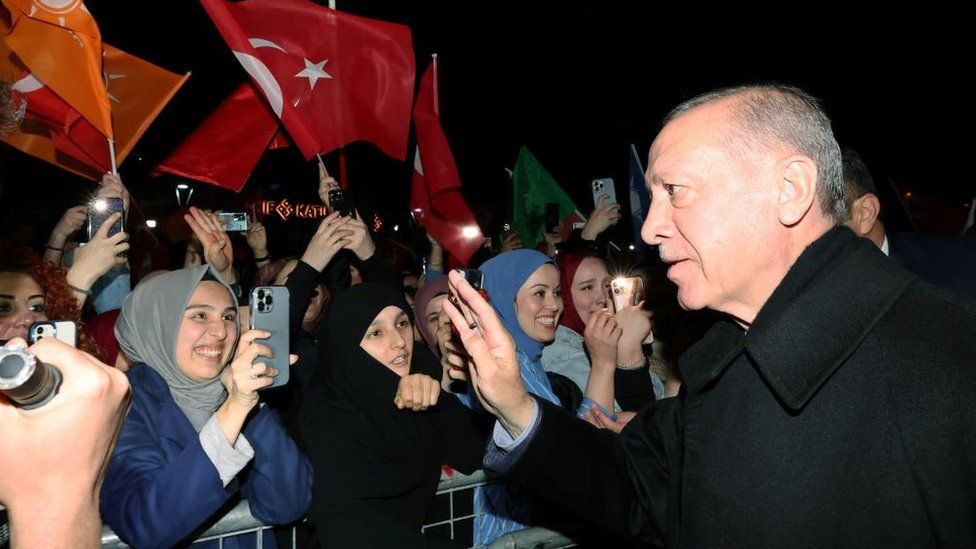 Turkish President Tayyip Erdogan greets his supporters arsenic  helium  leaves his residence successful  Istanbul, Turkey May 14, 2023.