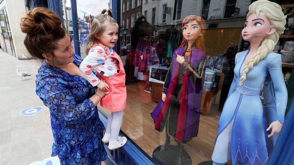 A mother and daughter at window of Disney Store in Dublin, 7 Jun 20