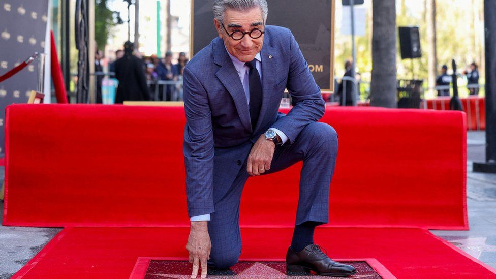 Canadian actor and comedian Eugene Levy (C) poses during his Hollywood Walk of Fame ceremony in Los Angeles