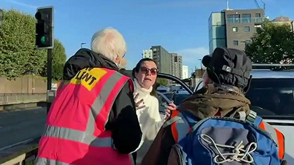 Motorist confronting climate protesters