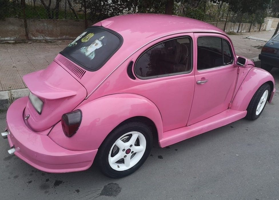 The pink VW with a portrait of Bashar al-Assad in the rear window