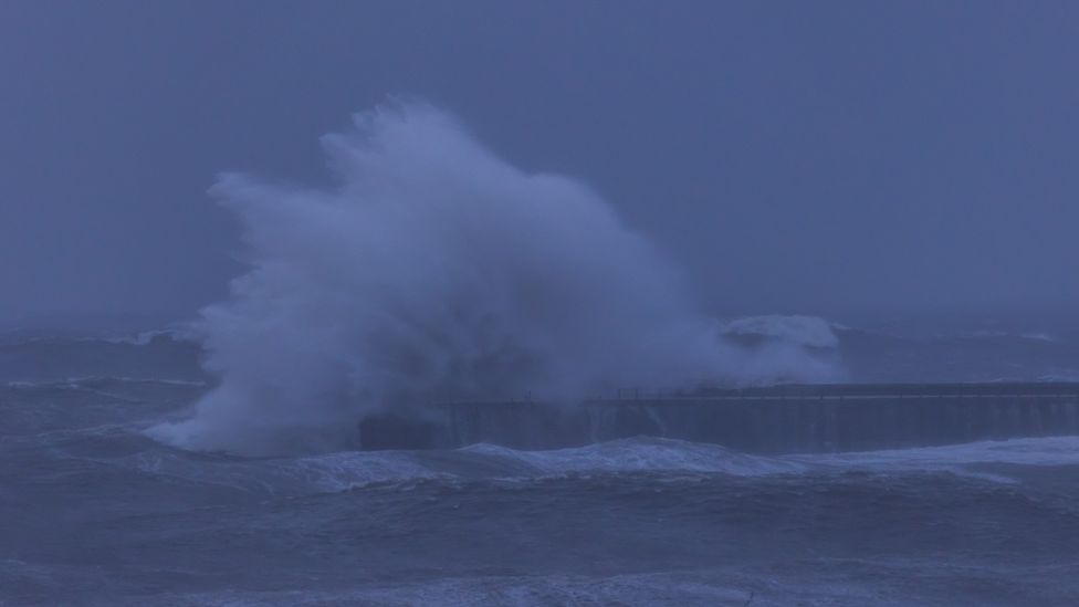 The wave fully engulfs South Shields Lighthouse