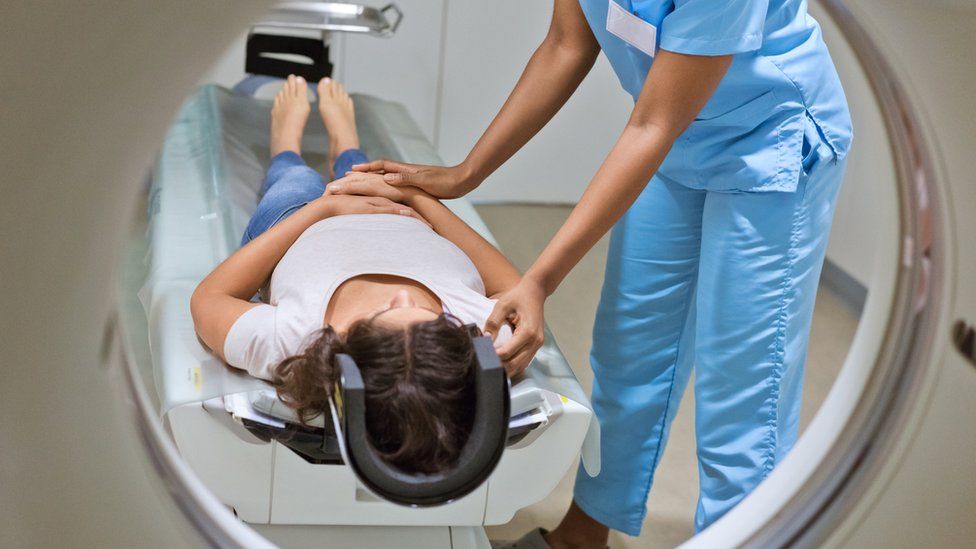 A woman being put in an MRI machine