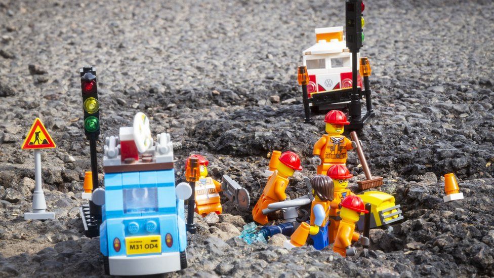 Lego men in pothole