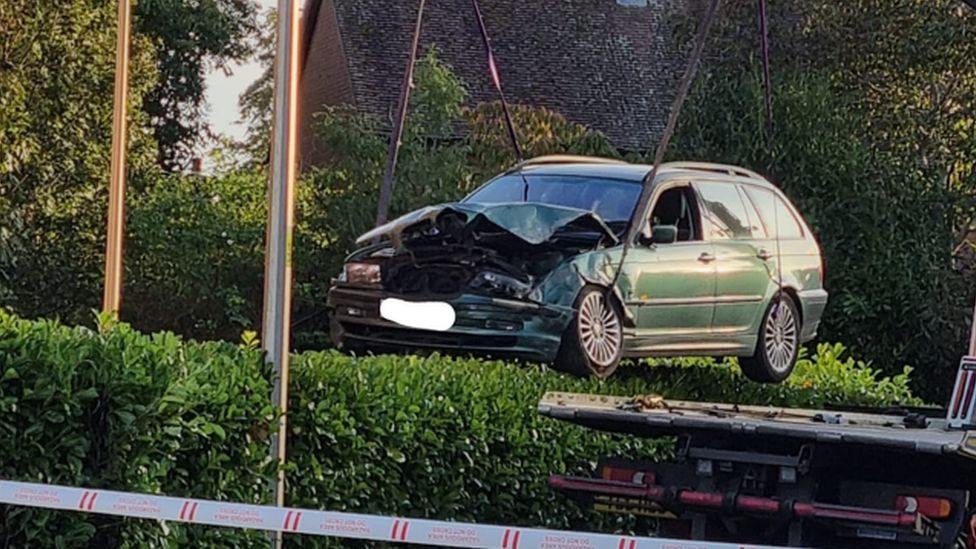 A damaged BMW being recovered from the crash scene