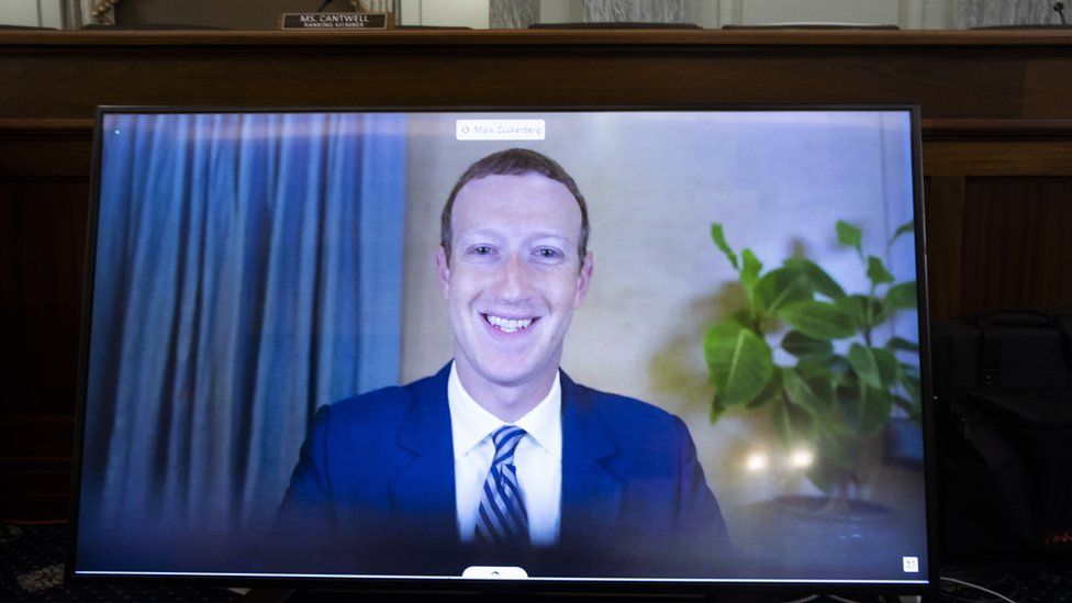 CEO of Facebook Mark Zuckerberg appears on a monitor as he testifies remotely during the Senate Commerce, Science, and Transportation Committee