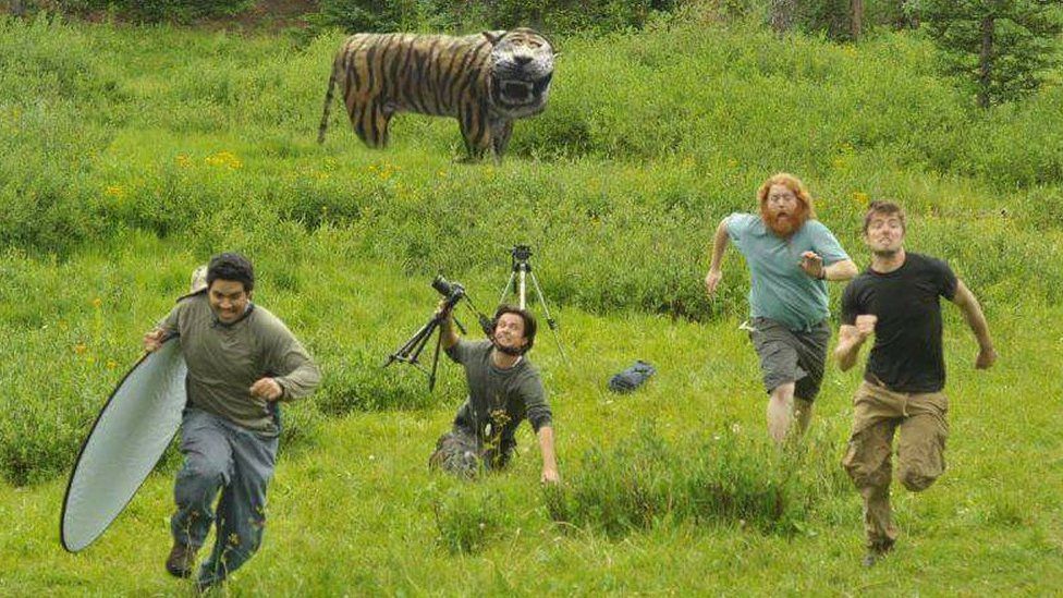 Mock up of film crew running away from the tiger