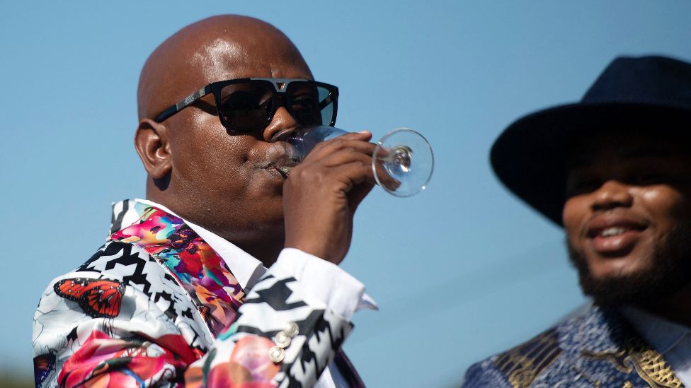 A man sipping from a champagne at The Met horse race in Cape Town, South Africa - Saturday 29 January 2022