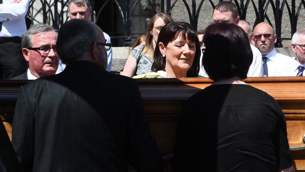 Family and friends carry Seamus Ruddy's coffin